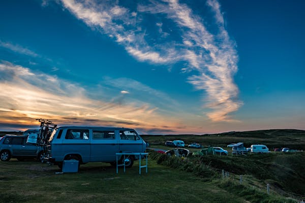 Camper van parked in a field at a campground